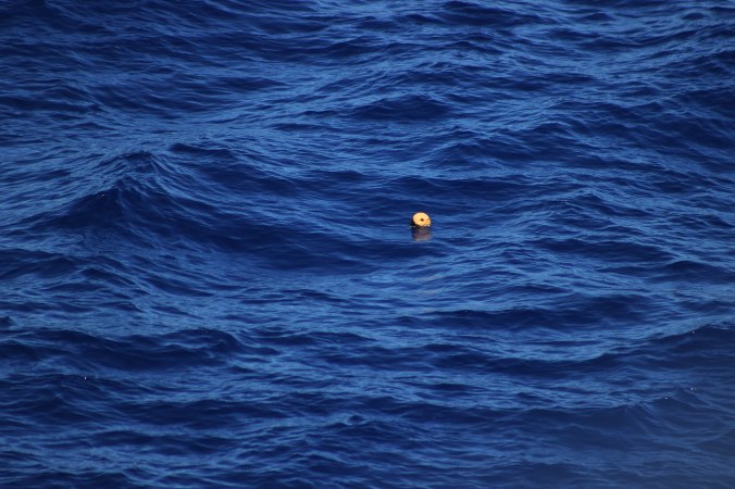 17 Unidentified trash debris floating in the Pacific Ocean a few days out from Hawaii between Hawaii and Japan